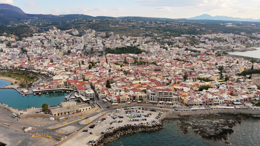 Aerial drone view of the historic old town and the Neratze Mosque minaret rising above red-tiled rooftops, Rethymno, Greece