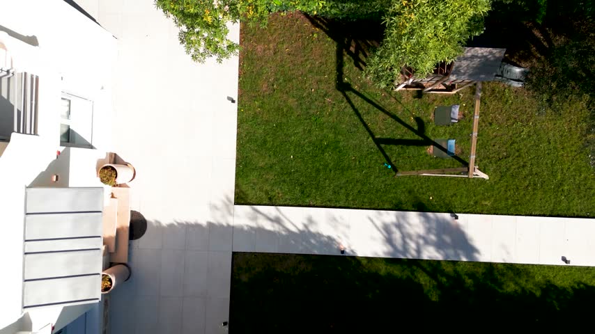 Modern house exterior featuring a patio, garden, and green lawn in La Rochelle, France.