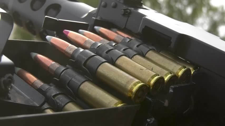 Large quantity of machine gun ammunition loaded into an ammunition box, prepared for military use. Ammunition, military equipment, armed conflict, and combat operations during the Russo-Ukrainian War concept.
