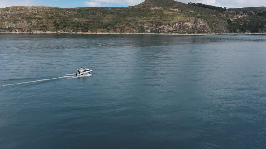Drone footage of the blue waters and mountain shoreline of Lake Titicaca, Bolivia