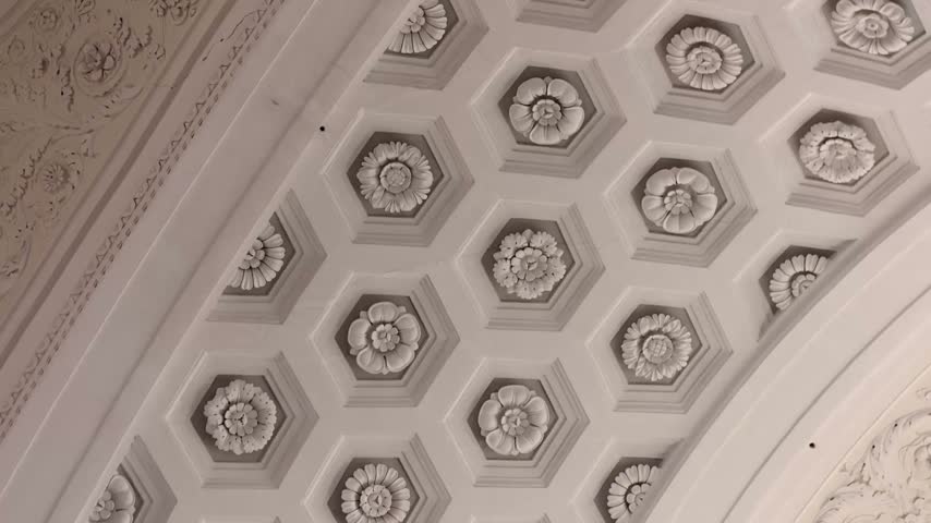 Ornate coffered ceiling with floral reliefs inside historic basilica in Imperia, Italy