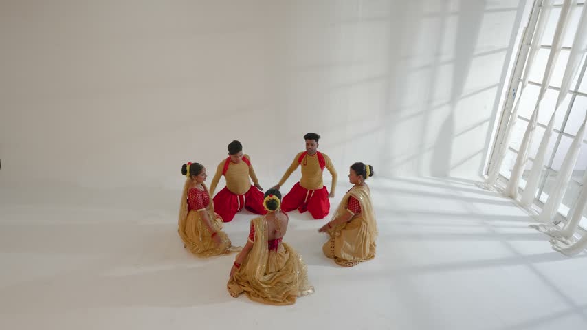Dancers are performing traditional Indian choreography in a studio