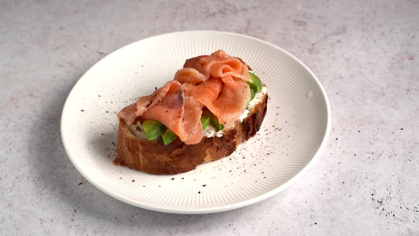 Bruschetta with salmon and avocado on a light background