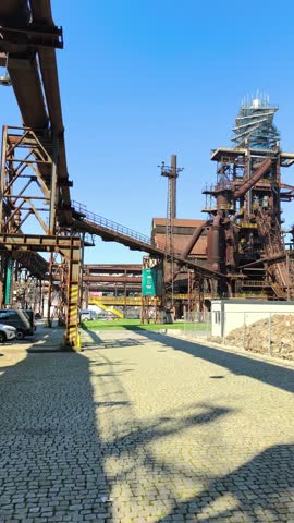Vertical shot of a historic blast furnace and steel structures at the Lower Vítkovice complex in Ostrava, Czechia.