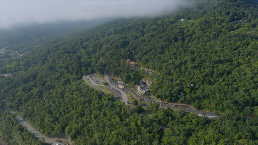 Aerial drone view of a mountain overlook and visitor complex near Chattanooga, Tennessee, surrounded by dense forest and fog.