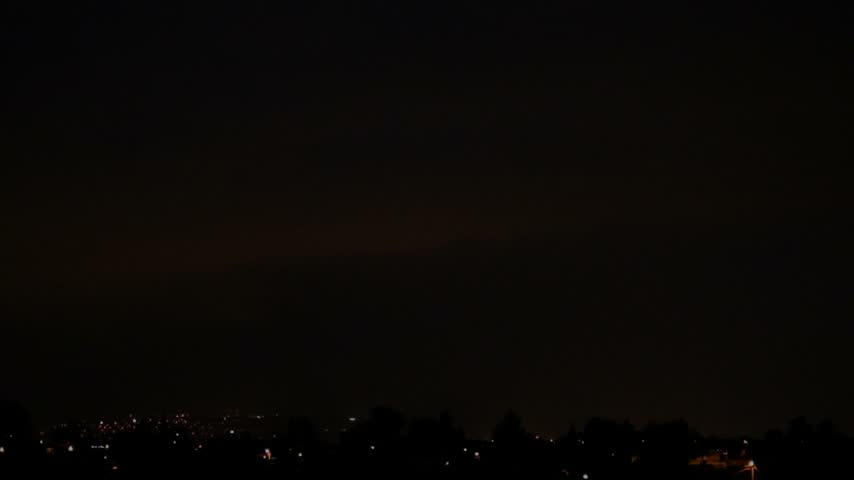 Thunderstorm with Lightning Over a City. Powerful Lightning Flashes Above an Urban Landscape. Bright Lightning Illuminating the City Skyline.