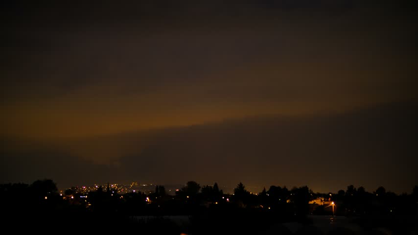Thunderstorm with Lightning Over a City. Powerful Lightning Flashes Above an Urban Landscape. Bright Lightning Illuminating the City Skyline.