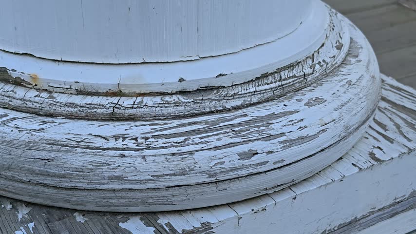 base of white antique column with cracks.