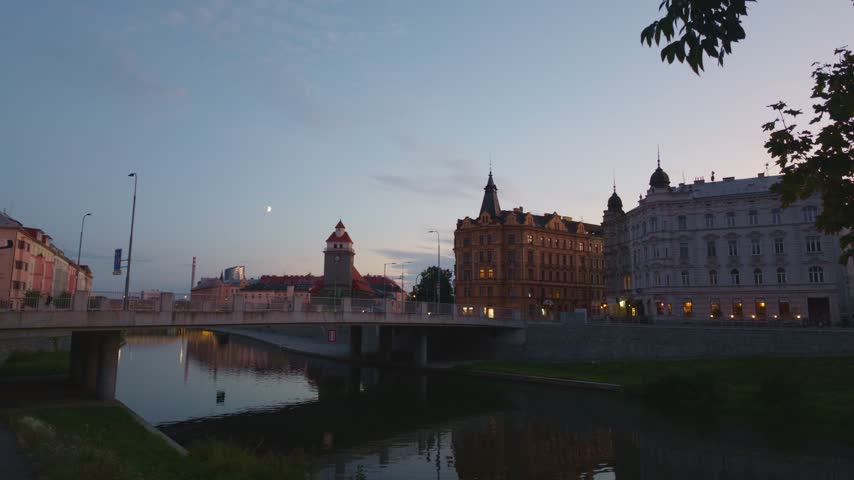 View of historic architecture along the Morava River at dusk in Olomouc, Olomouc Region, Czechia.