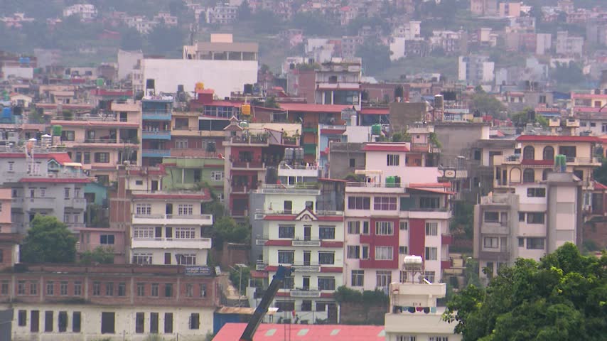 Kathmandu city skyline and dense urban residential architecture in Nepal, captured in a wide establishing shot. High density housing and building structures across the valley landscape