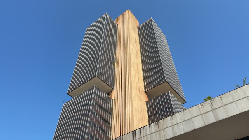 Banco Central do Brasil offices in Brasilia City, Brazil, showing its distinctive high-rise tower, concrete architecture and landscaped urban setting, handheld close-up