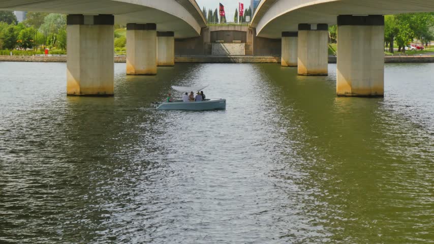 Boat going under a bridge