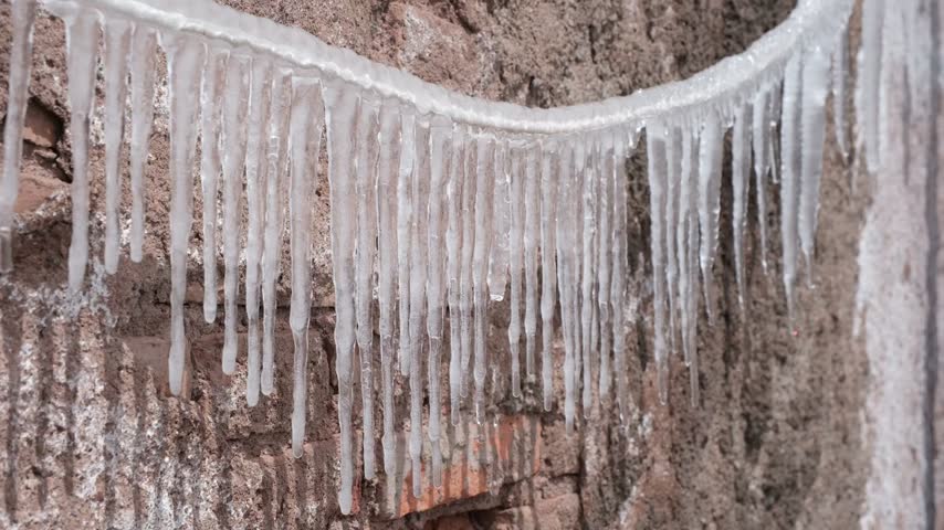 Icicles form on a rope in cold weather mountain park, perfect for seasonal video