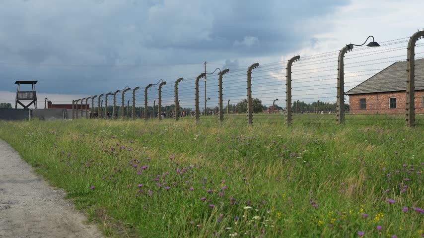 OSWIECIM, POLAND Historic main entrance gatehouse and wooden barracks at the Auschwitz II-Birkenau concentration camp