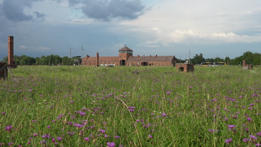 OSWIECIM, POLAND Historic main entrance gatehouse and wooden barracks at the Auschwitz II-Birkenau concentration camp