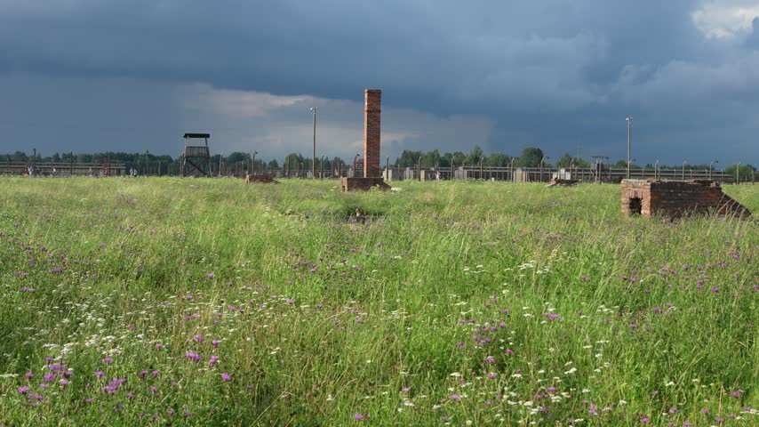 OSWIECIM, POLAND Historic main entrance gatehouse and wooden barracks at the Auschwitz II-Birkenau concentration camp