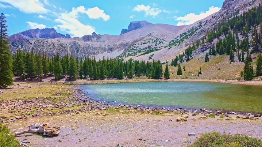 Panoramic view of pristine alpine waters reflecting rugged mountain ridges at Stella Lake in Great Basin National Park Nevada