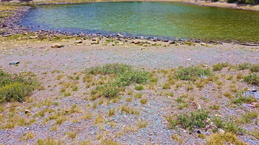 Panoramic view of pristine alpine waters reflecting rugged mountain ridges at Stella Lake in Great Basin National Park Nevada