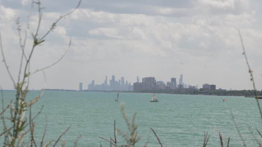 Scenic view of Lake Michigan with the Chicago skyline in the background and boats cruising across the water video