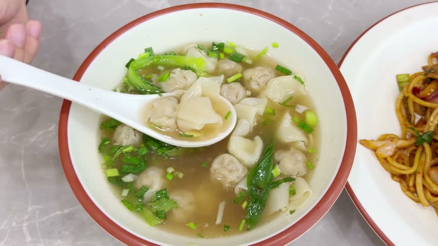 Chinese Restaurant Table with Noodles on Plate and Wonton Soup in Bowl – Traditional Dumplings and Noodle Dish	
