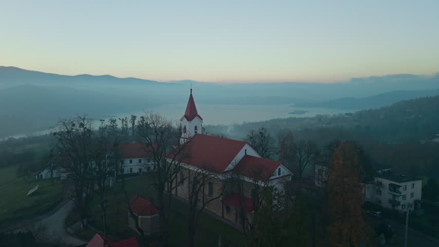 Aerial view of historic St. Adalbert Church steeple in Mucharz, Poland