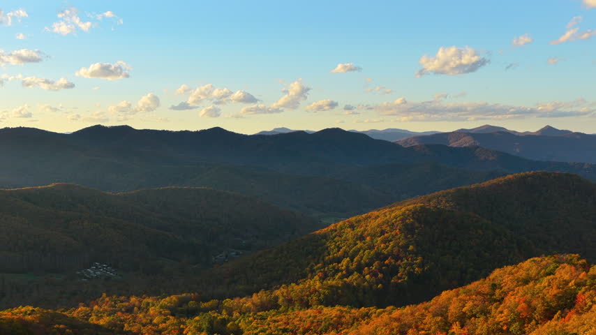 Sunset autumn view of Appalachian forest hills. Lush woods with golden trees in colorful fall season.