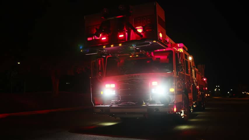 Fire truck engine responding to emergency call at night
