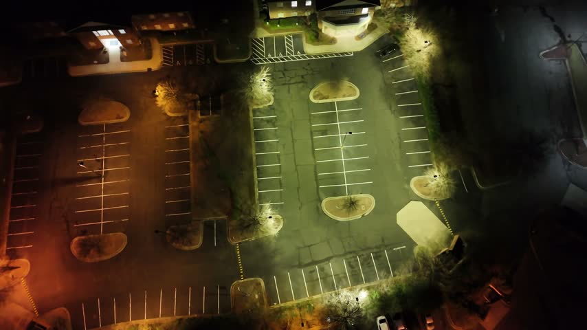 Fog rolling through empty parking lot aerial view