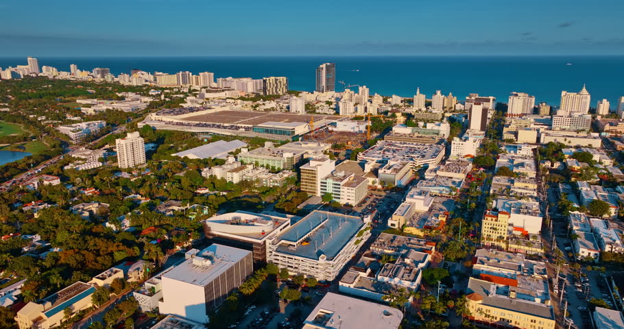Splendid sunlit panorama of Miami, Florida, USA at sunset. Drone footage over the picturesque cityscape approaching the waterscape.