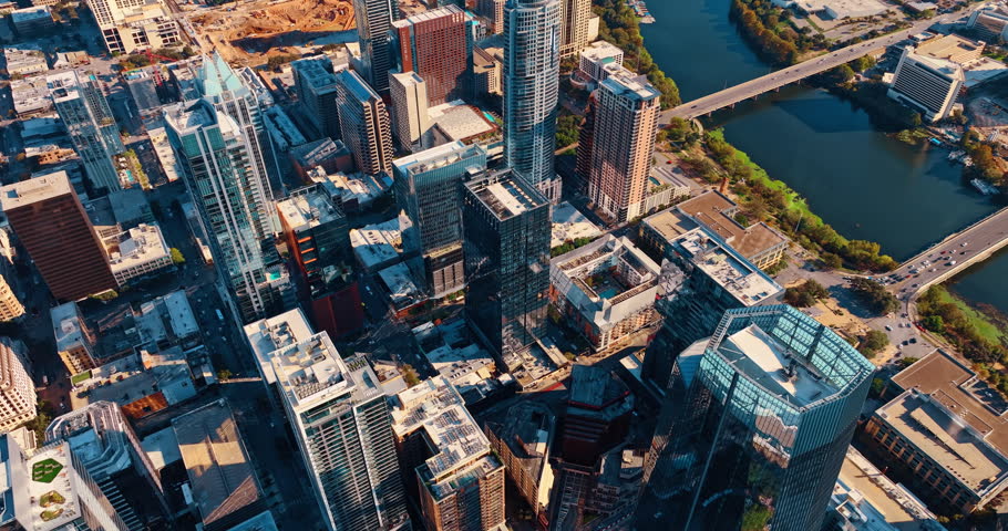 Flying high over the urban landscape of downtown Houston, Texas, USA. View on the Colorado River with lively traffic on bridges.