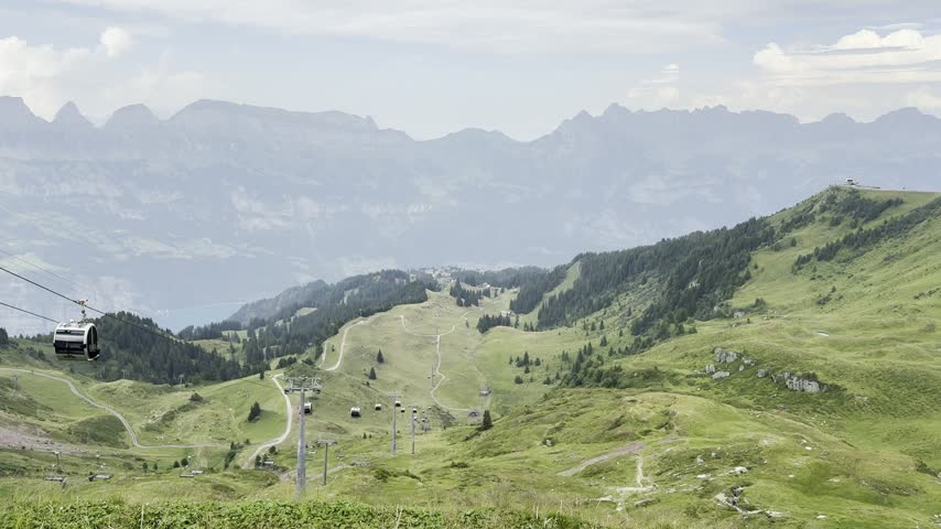 Chairlift Ride Above Alpine Meadow with Walensee View in Switzerland