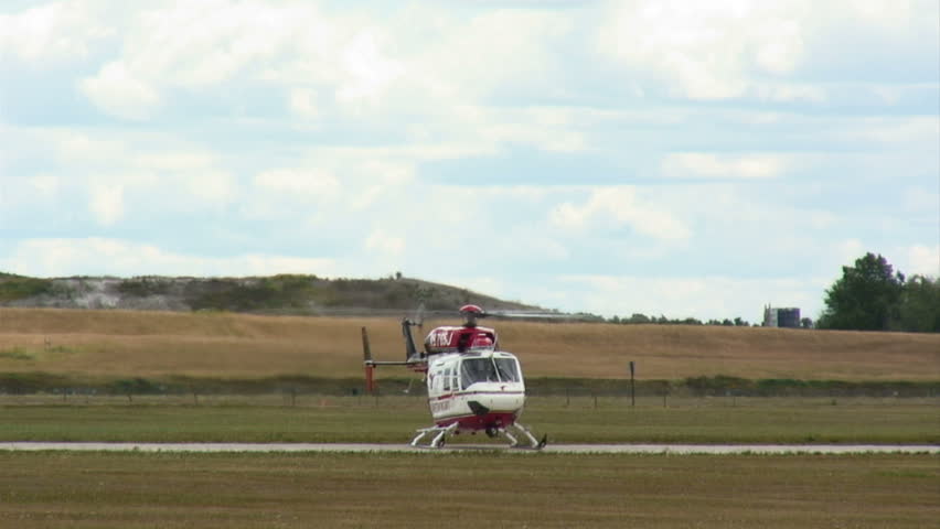 Medical helicopter takes off from an airfield.