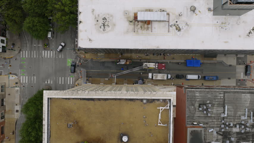 Top-down drone view over rooftops and a city street in Chattanooga, Tennessee, with a fire truck