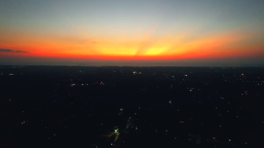 Sunset over the city, orange sky, beach sunset