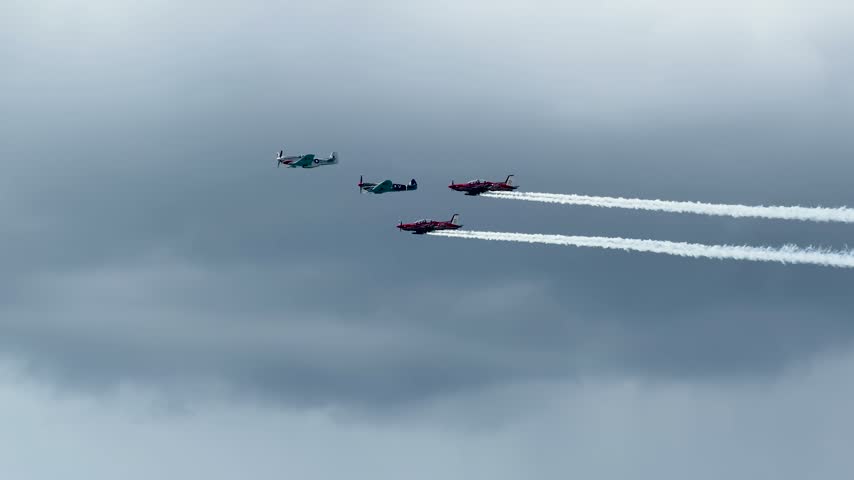 Stunt planes fly in formation with smoke trails during an airshow in Gold Coast, Australia.