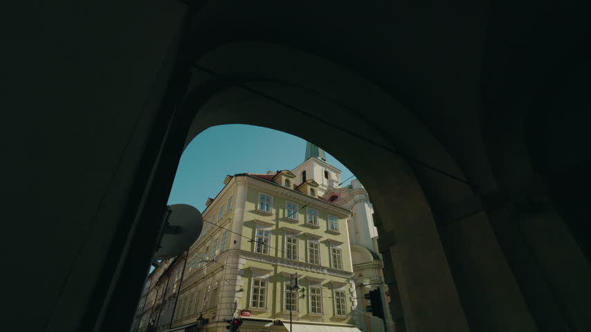 Baroque Church of St Thomas rises above historic streets in Prague