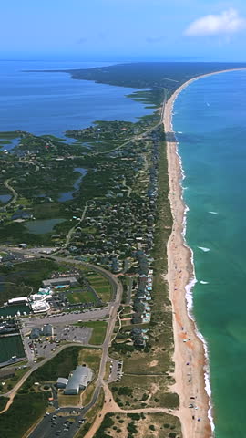 Barrier island coastline of the Outer Banks in North Carolina, United States, showing the sandy shoreline, Atlantic Ocean and coastal landscape - vertical shot