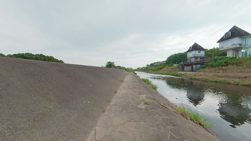 Walking Along a Stone-Paved Path by the River