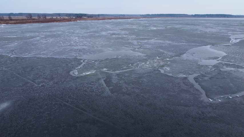 Last brittle and dangerous ice with crack on the lake in the spring.