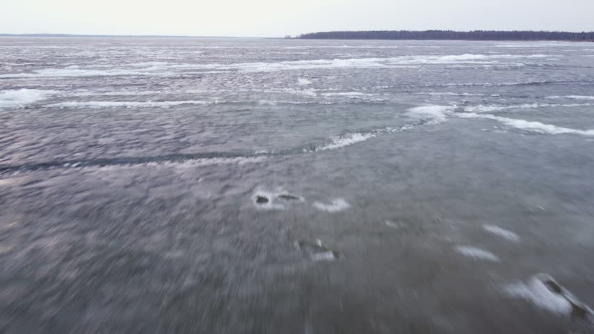 Last brittle and dangerous ice with crack on the lake in the spring.