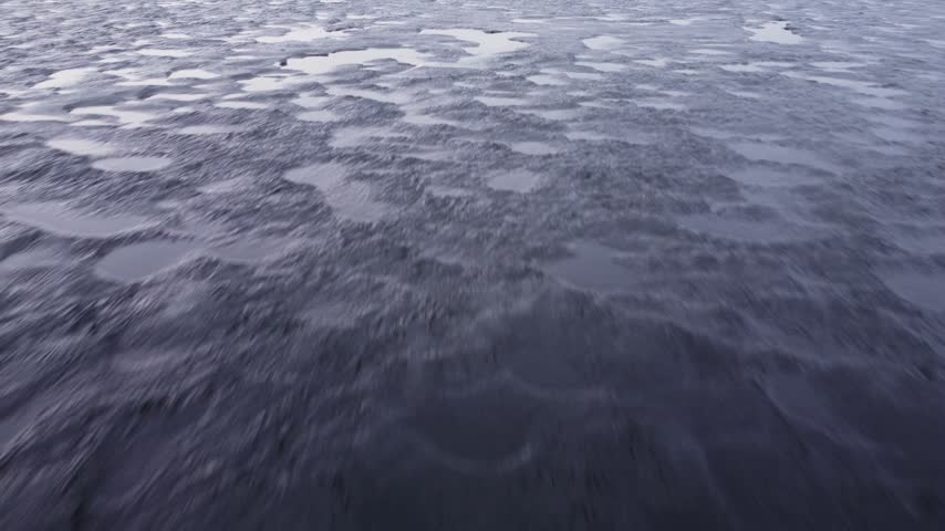 Last brittle and dangerous ice with crack on the lake in the spring.