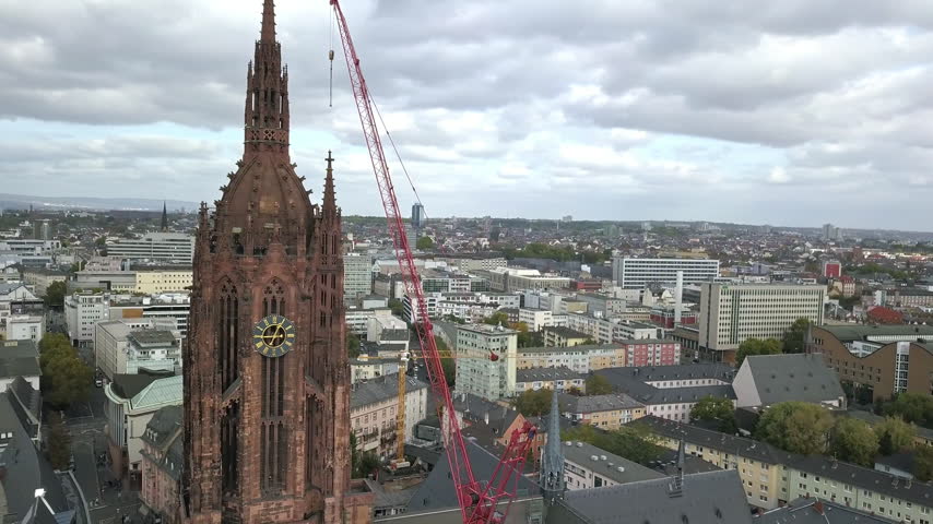Aerial drone footage of the city center, business district and a big cathedral in Frankfurt am Main in Germany, European Union. Frankfurt is the financial and banking capital of Germany and Europe.
