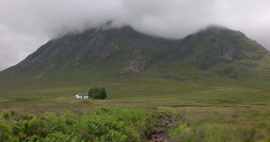 medium shot of the famous white hut in Glencoe on an overcast day