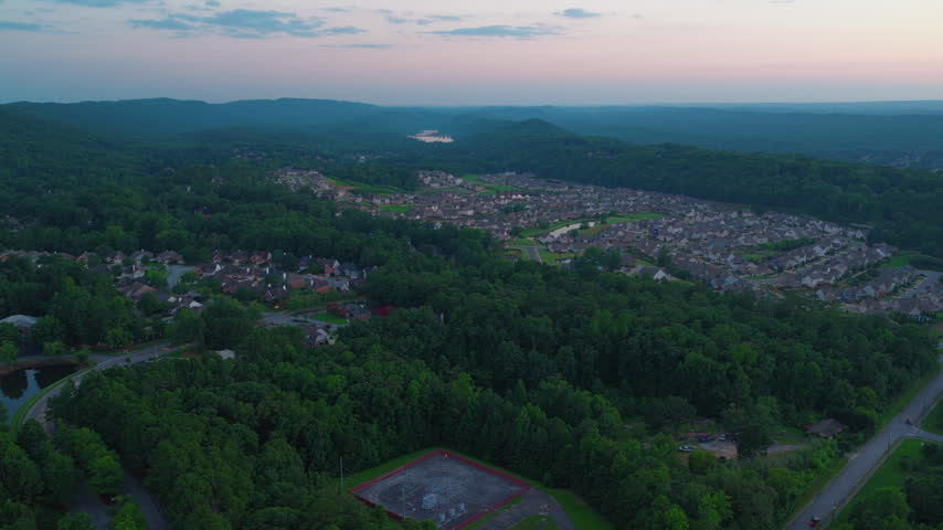 The exurban edge of the Birmingham metro, where new residential construction has filled a valley floor in Shelby County and is working up the slopes toward the ridge. US Highway 280