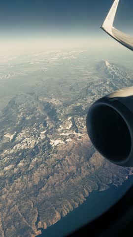 Airplane Wing View Over Mountainous Landscape During Flight