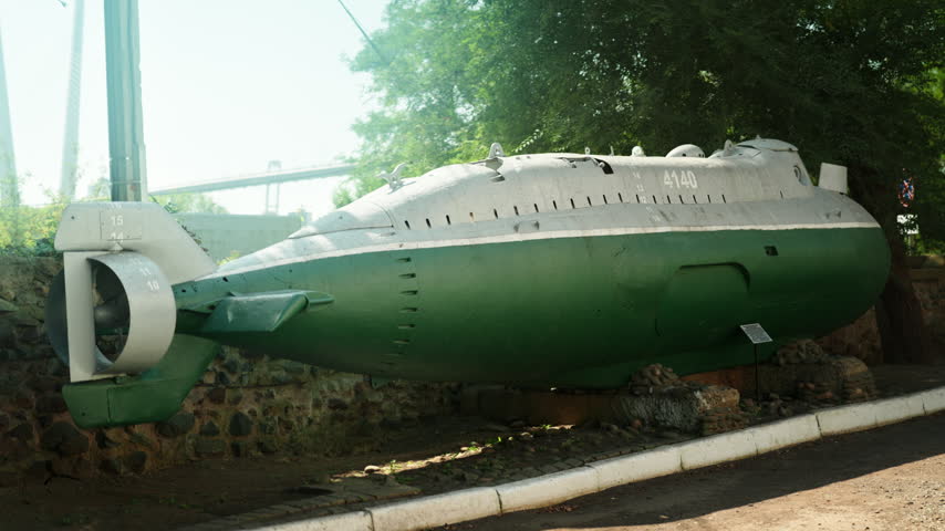 A green Soviet submarine stands in the middle of the street. Wartime era. World War III. The Soviet Union.