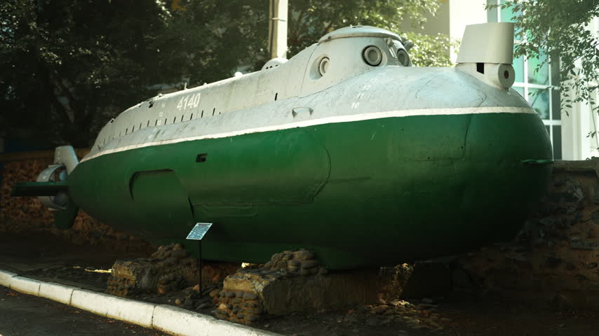A green Soviet submarine stands in the middle of the street. Wartime era. World War III. The Soviet Union.