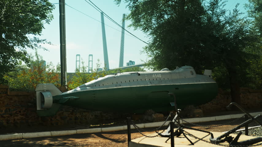 A green Soviet submarine stands in the middle of the street. Wartime era. World War III. The Soviet Union.