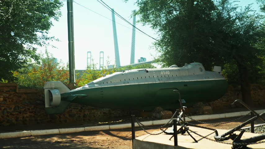 A green Soviet submarine stands in the middle of the street. Wartime era. World War III. The Soviet Union.