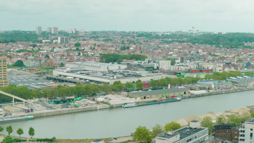 Wide skyline view over the Charleroi-Brussels Canal with the Atomium in the distance, surrounded by Brussels cityscape - Belgium